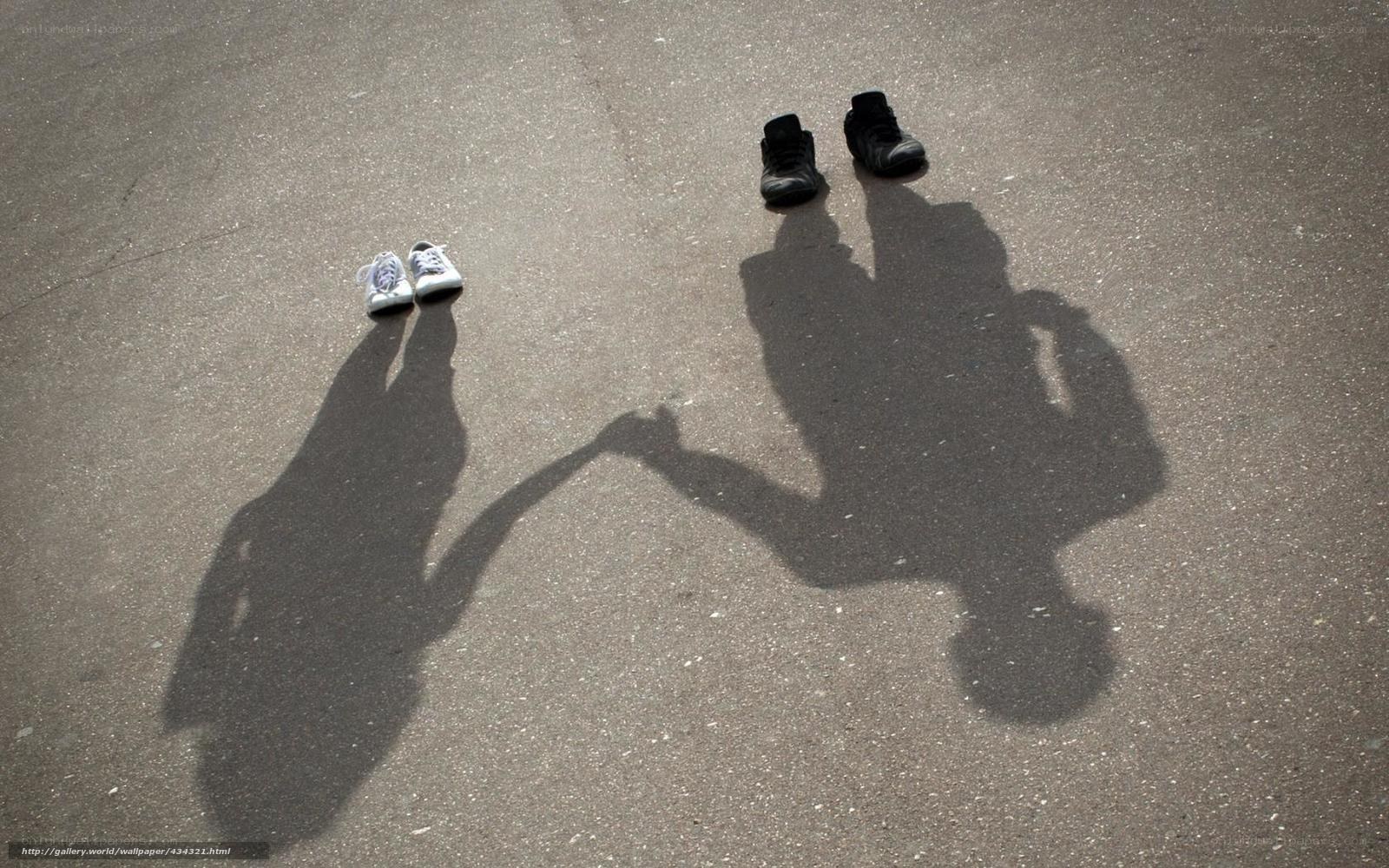 Shadows of two people holding hands