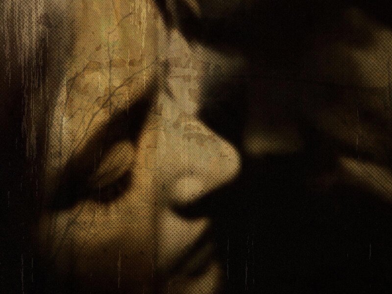 shadowy face in dark tones