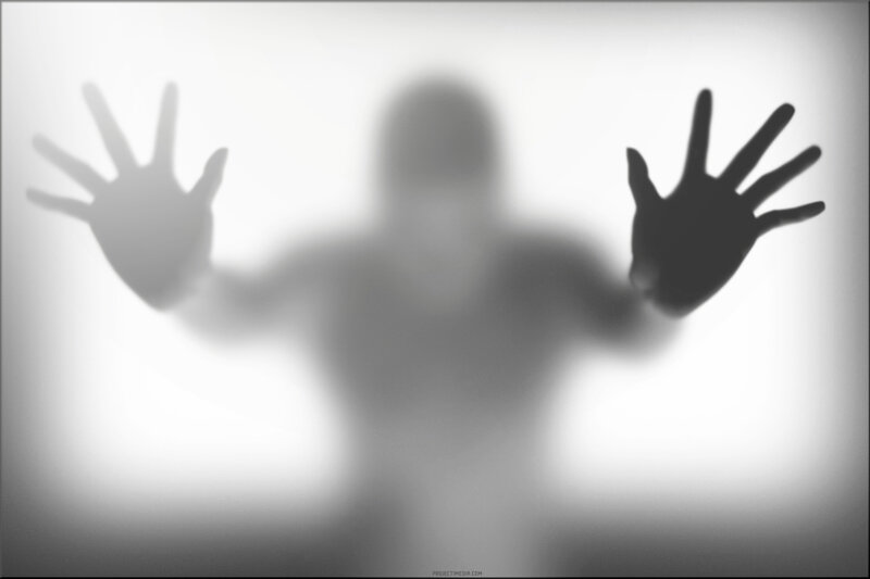 shadowy figure behind glass