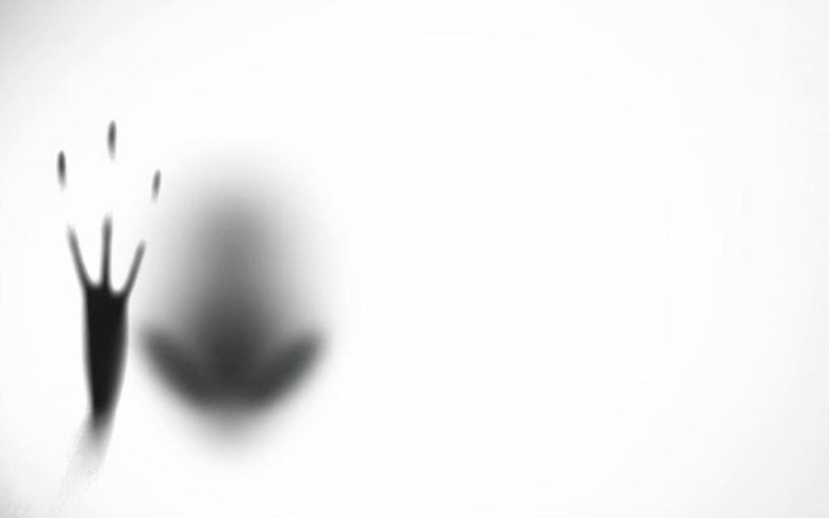 shadowy hand on glass