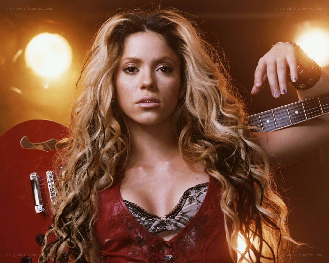 Shakira with red guitar