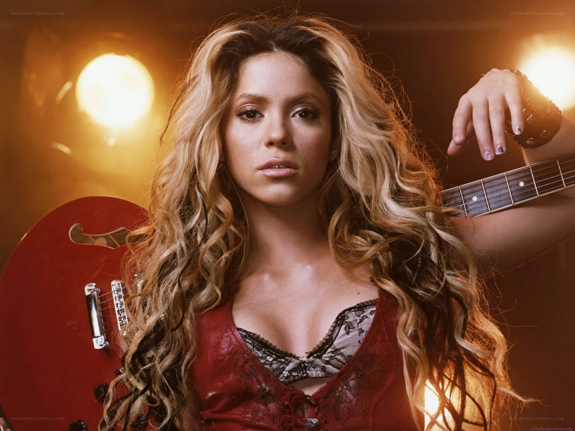 Shakira with red guitar