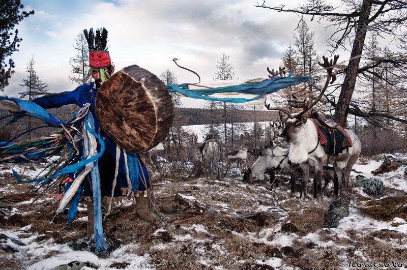 Shaman with reindeer in winter