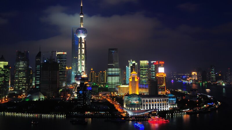 Shanghai Skyline at Night — Black, Dramatic, Photograph, Skyscrapers, River, Boats, Clouds, Blue, Yellow, Aurora