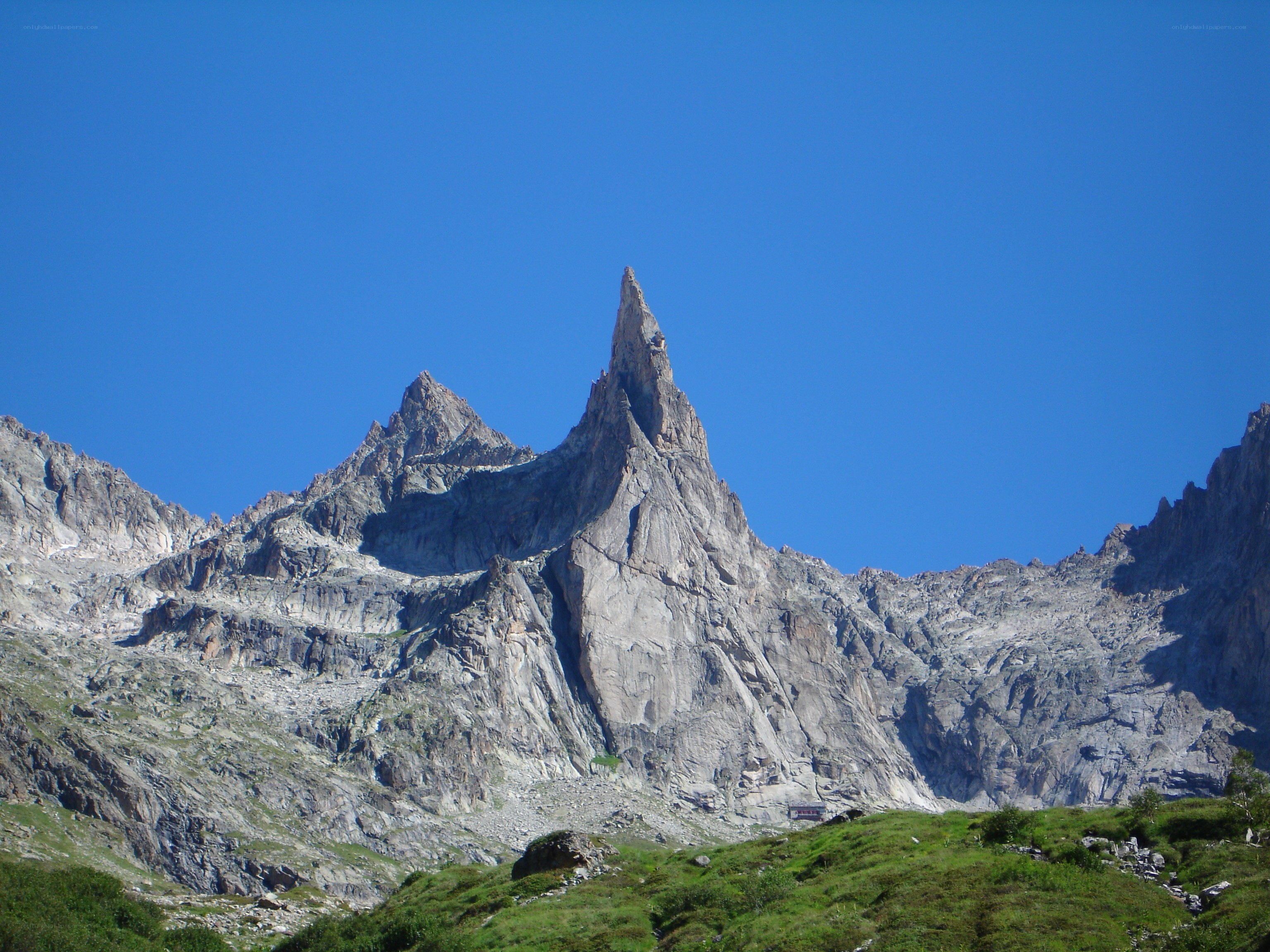 Sharp mountain peak under blue sky
