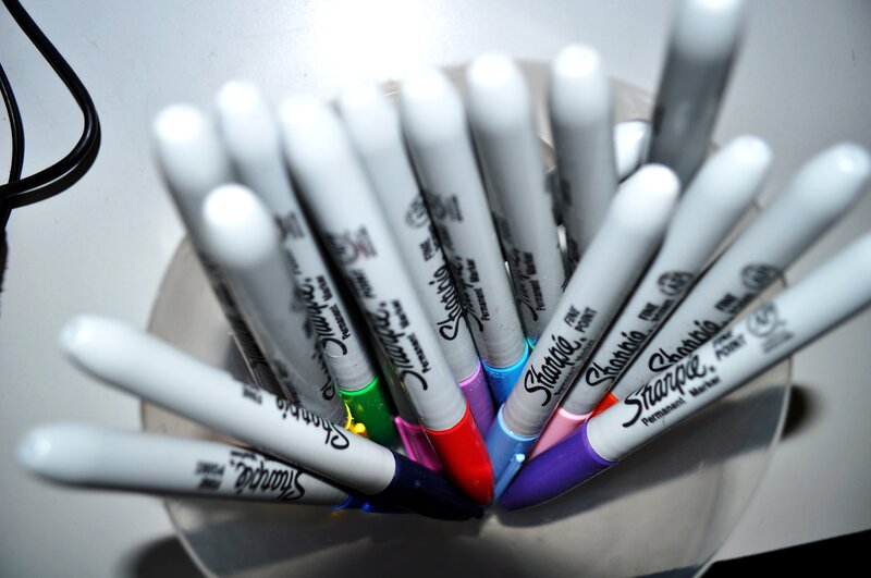 Sharpie markers in a cup