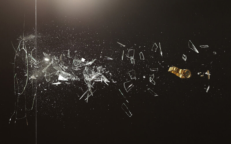 Shattered glass and gold watch