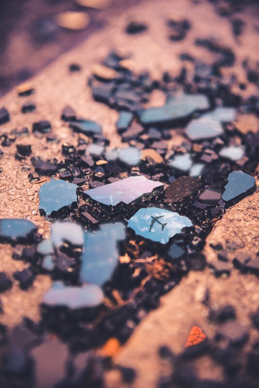 Shattered Glass with Airplane Reflection