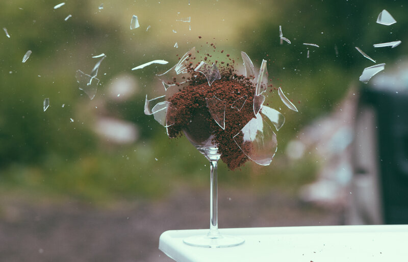 Shattered glass with coffee grounds