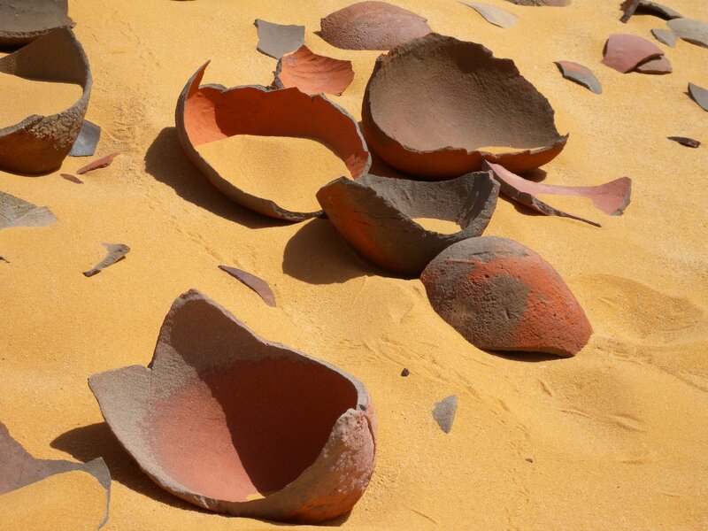 Shattered pottery in sand