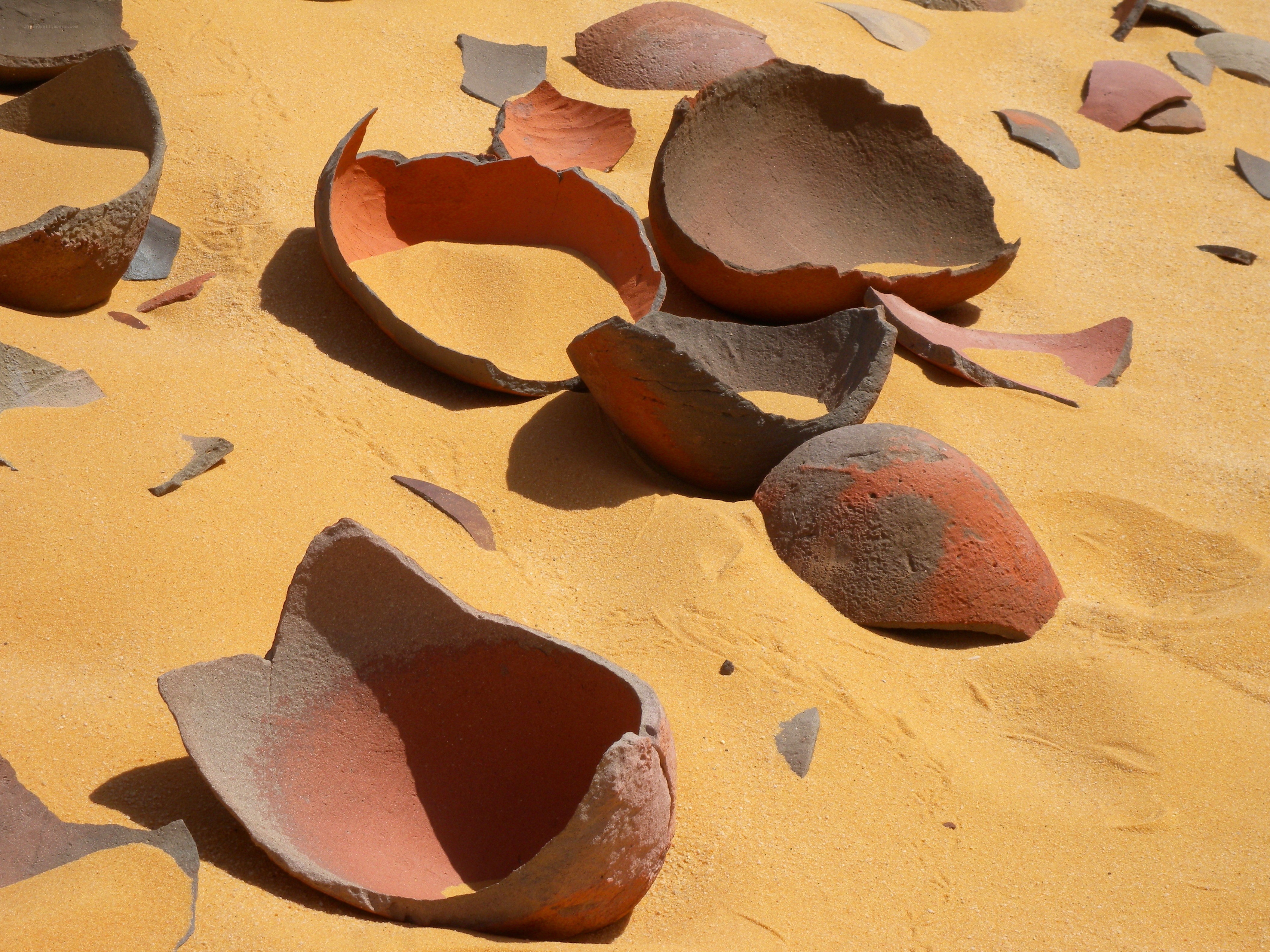 Shattered pottery in sand
