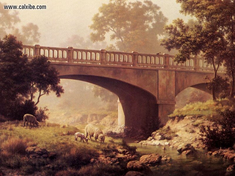 Sheep grazing under a bridge
