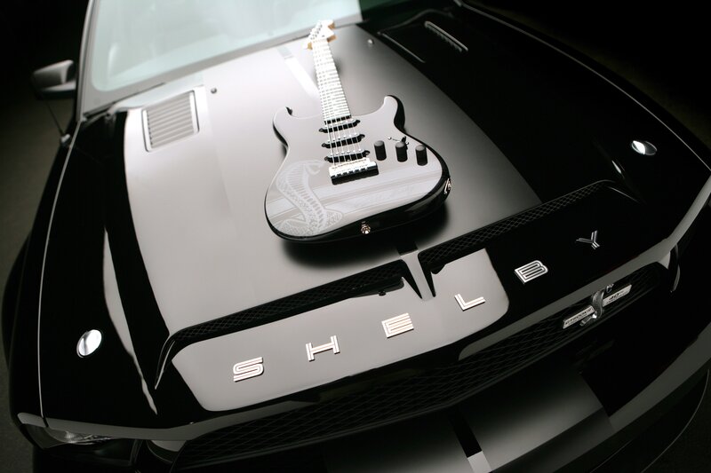 Shelby car with guitar on hood