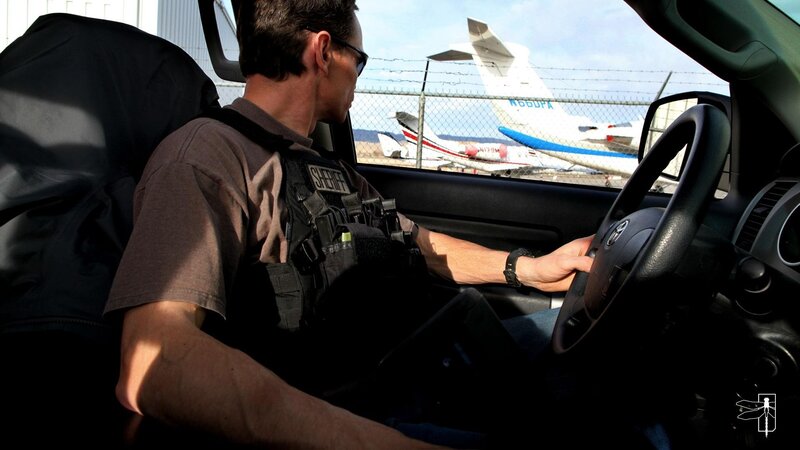 sheriff in car at airport