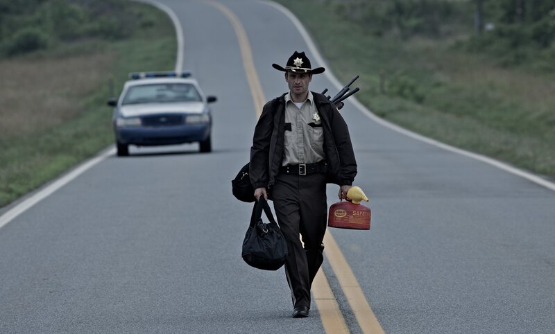 sheriff walking on road with gear
