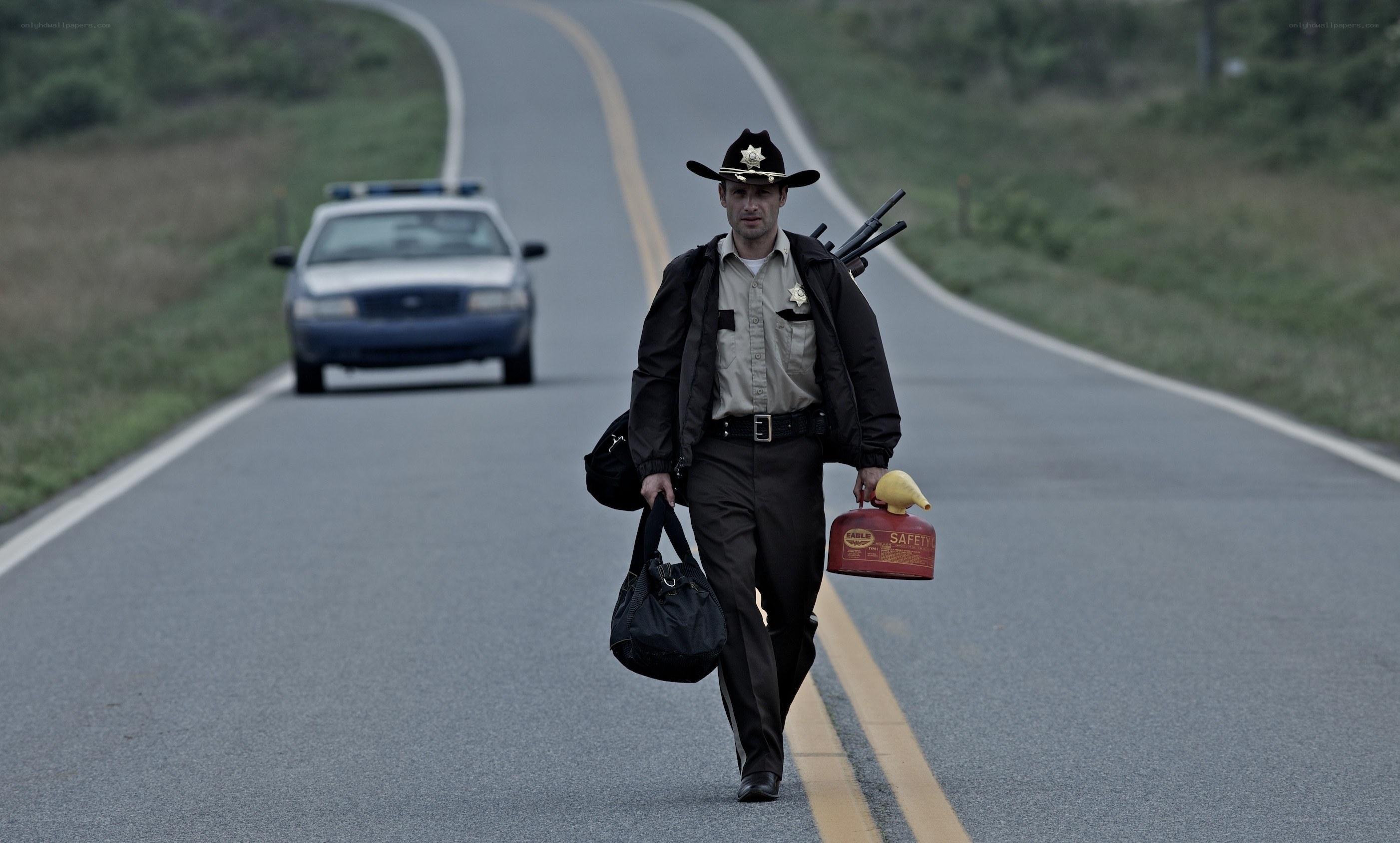 sheriff walking on road with gear