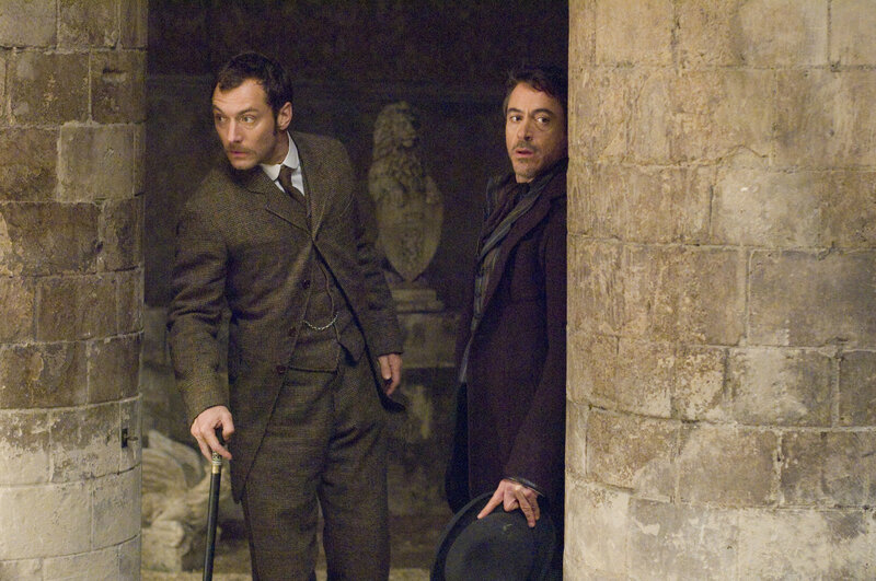 Sherlock Holmes and Dr. Watson in a corridor