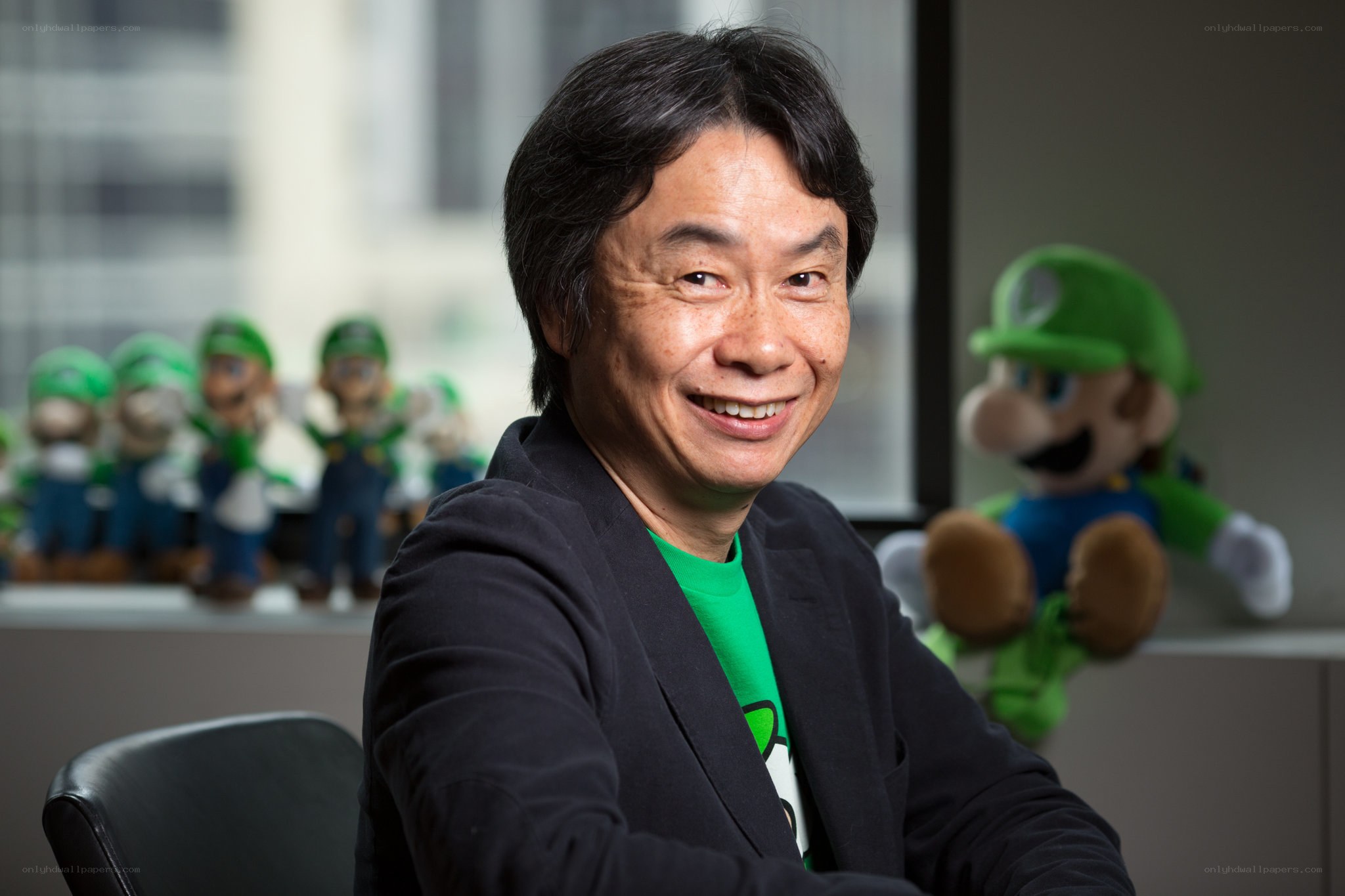 Shigeru Miyamoto with Luigi figures