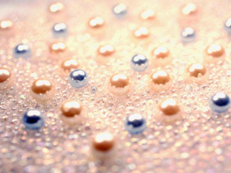 Shiny beads on glittery surface