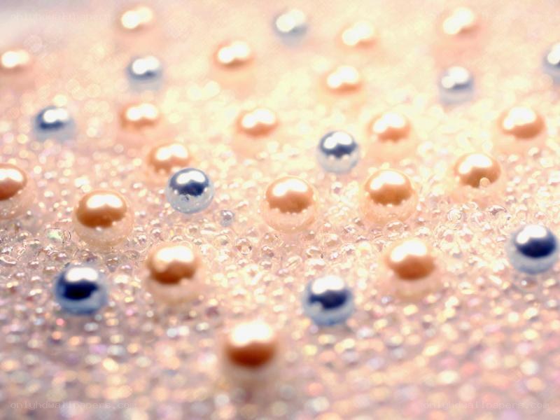 Shiny beads on glittery surface