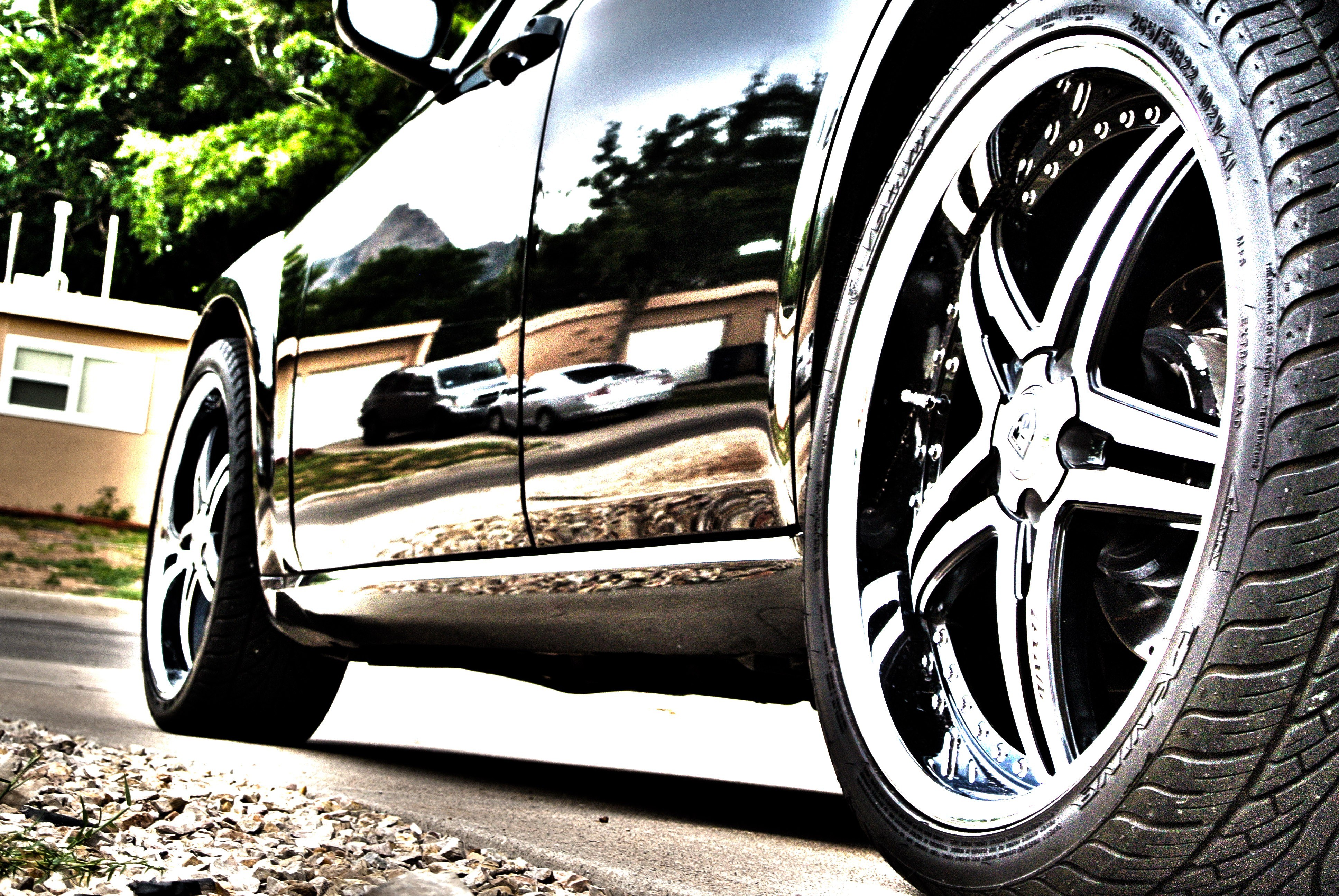 shiny black car with custom wheels