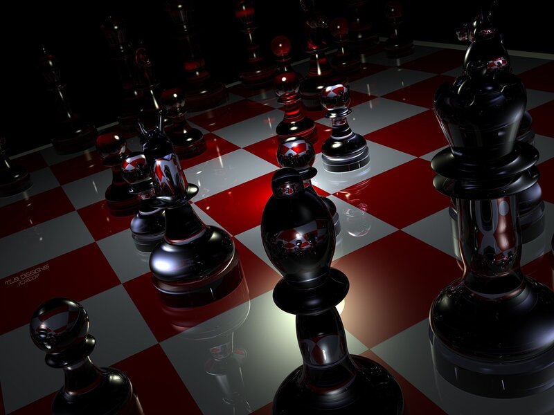 Shiny black chess pieces on red and white board