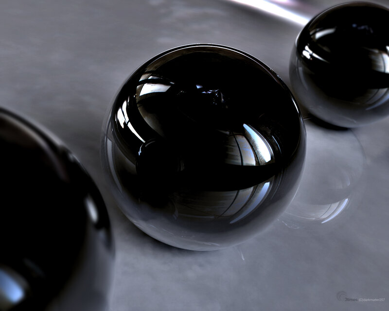 Shiny black spheres on gray surface