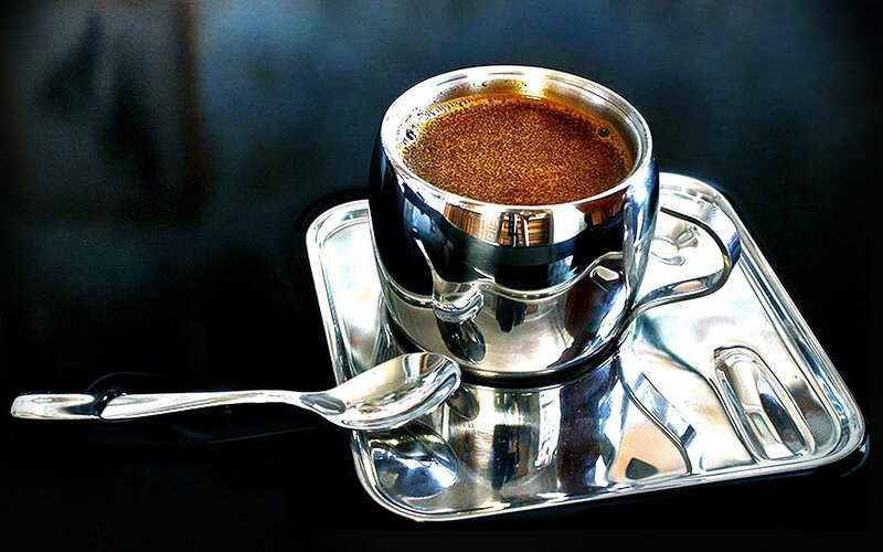 Shiny coffee cup on tray