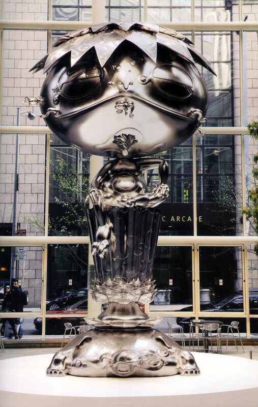 Shiny frog sculpture in city