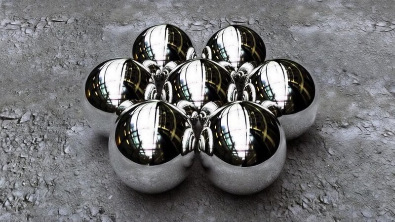 shiny metal spheres on concrete