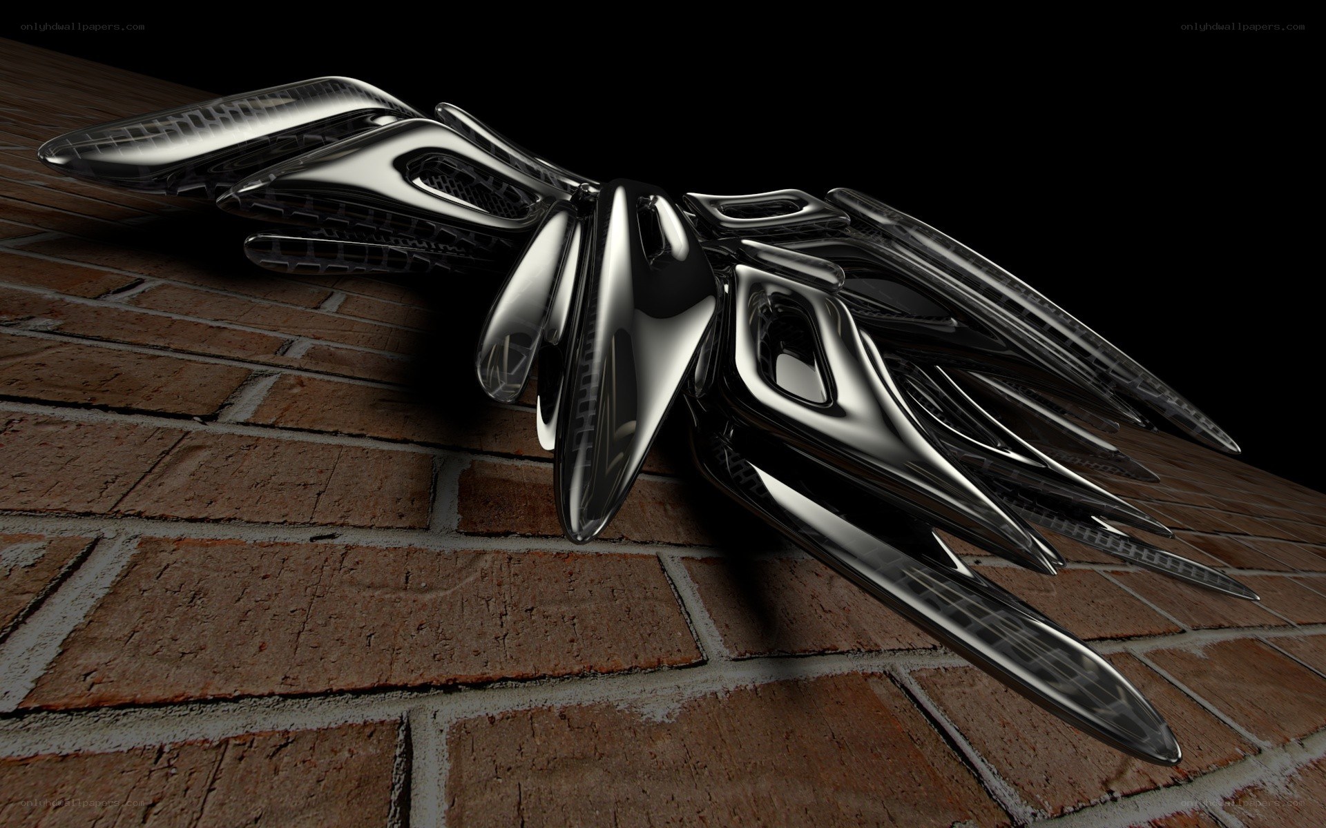 shiny metallic sculpture on brick