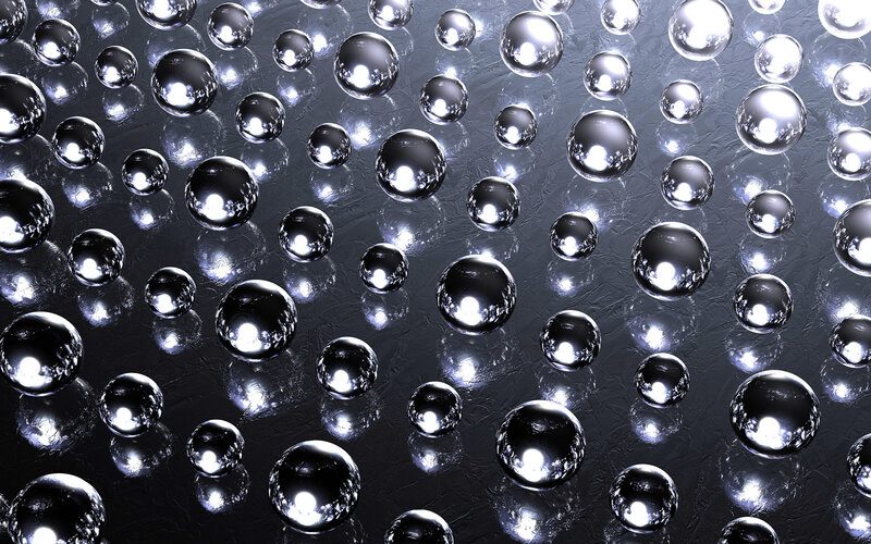 Shiny metallic spheres on dark surface