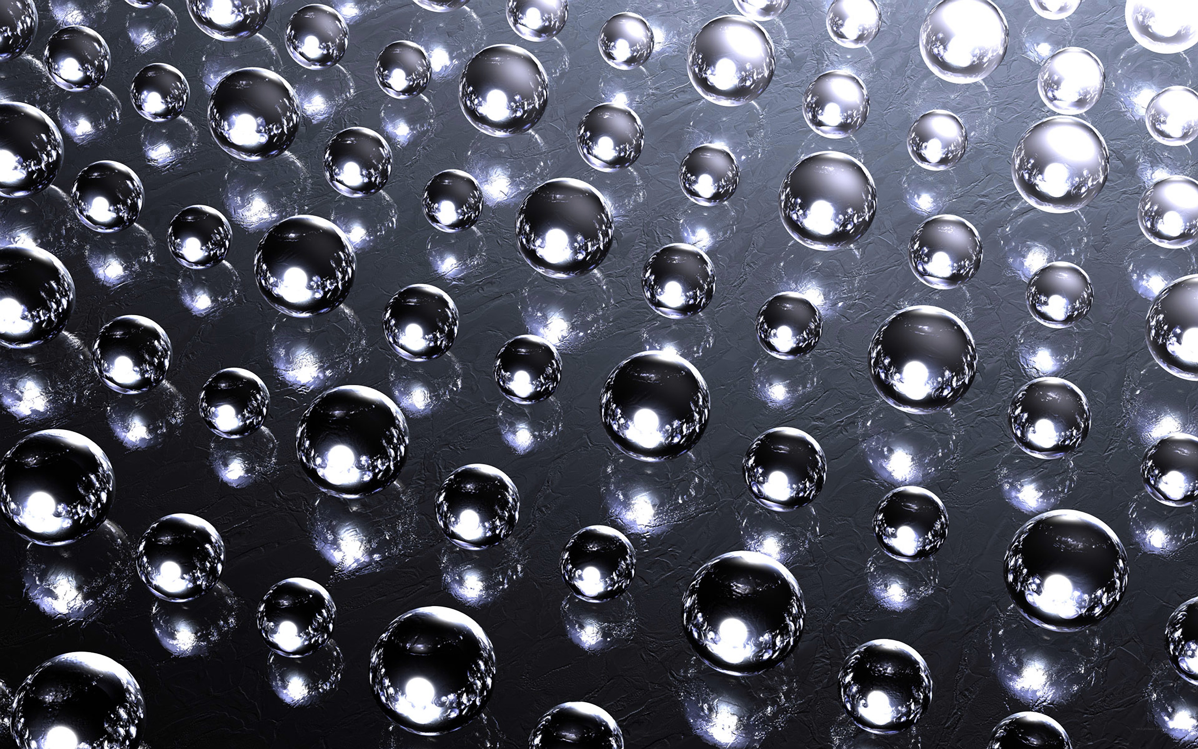 Shiny metallic spheres on dark surface