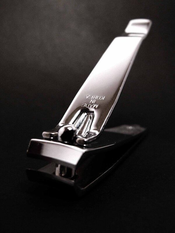 shiny nail clipper on black