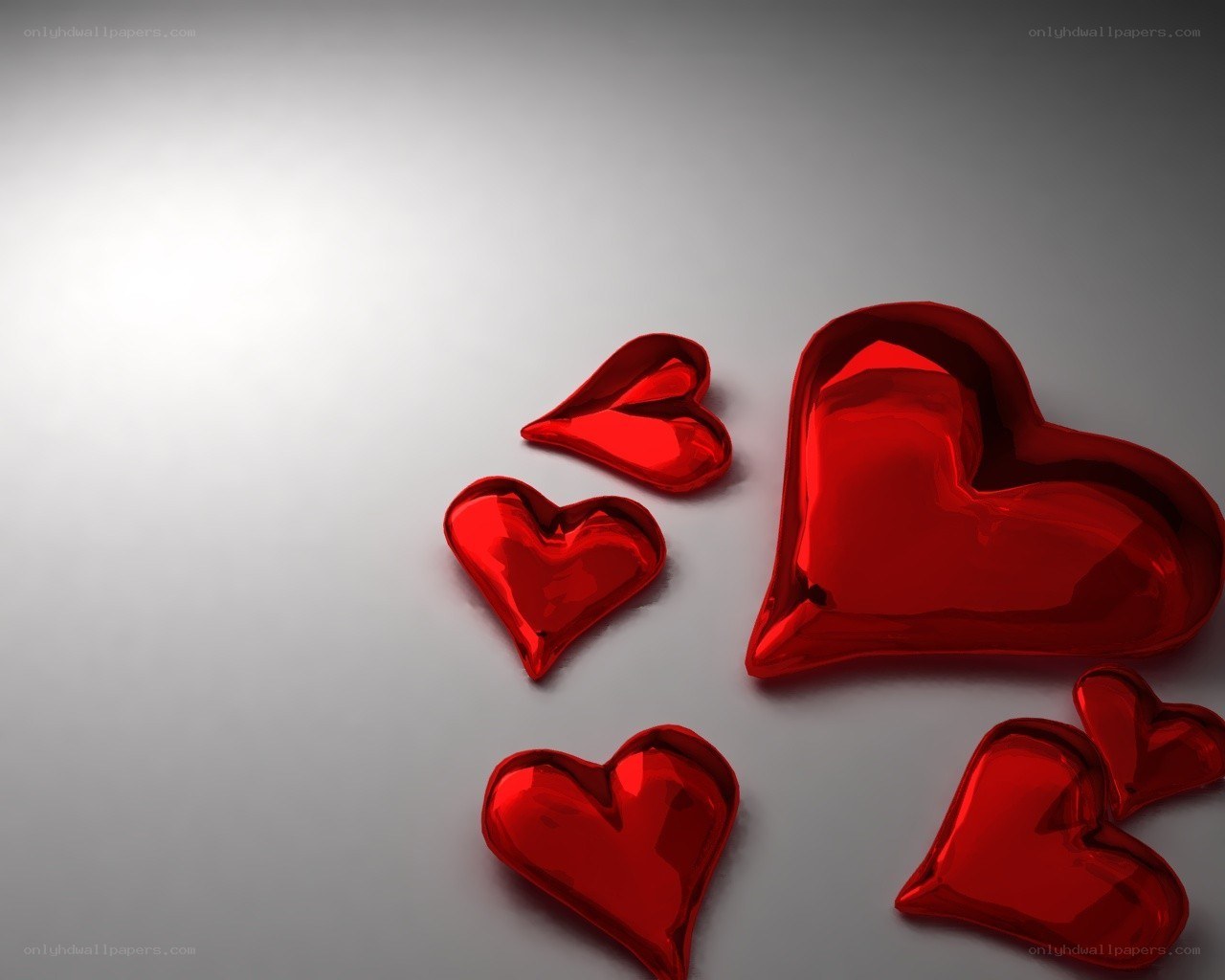 Shiny red hearts on gray