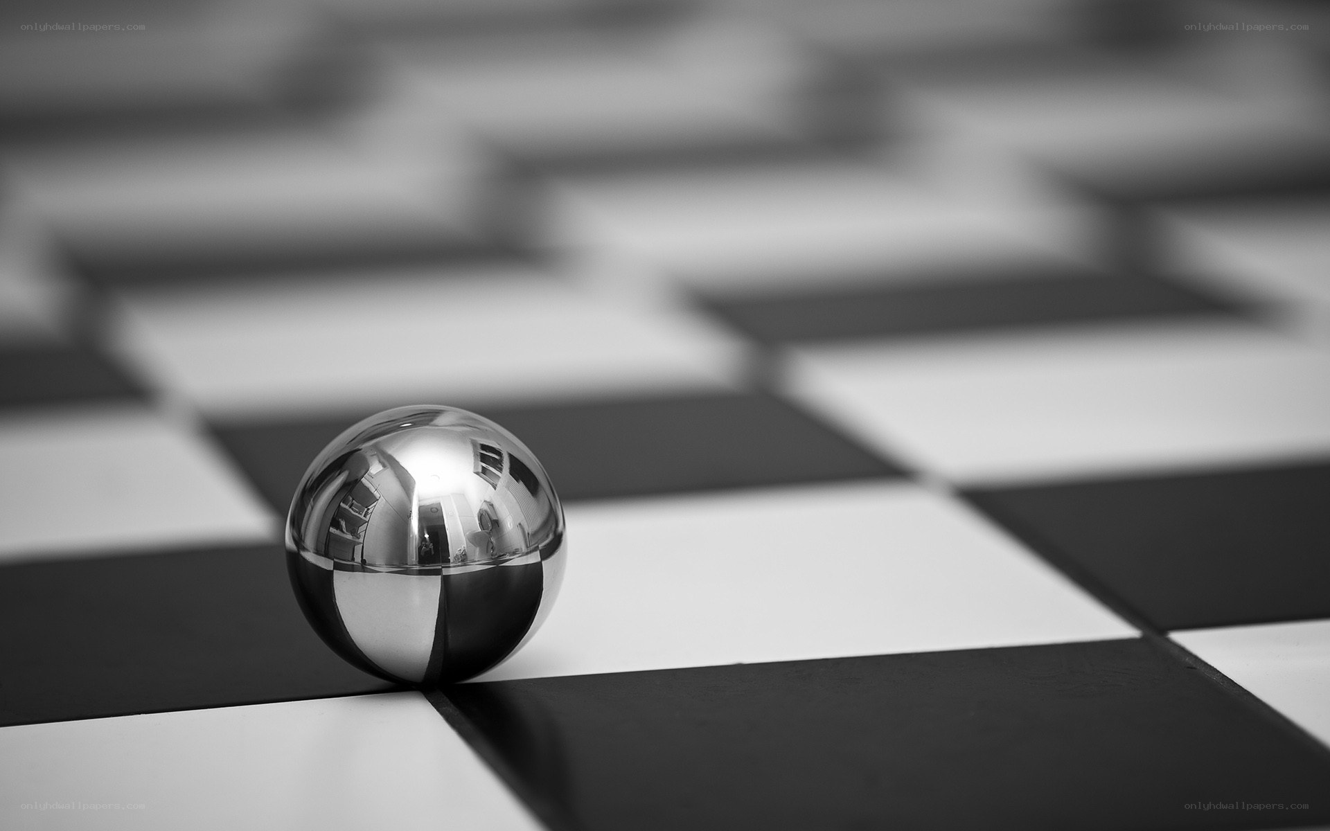 Shiny sphere on checkered floor