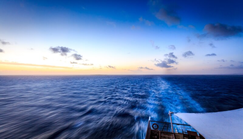 Ship at Sea During Sunset — Blue