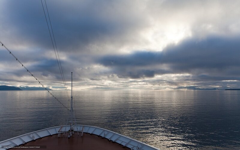 Ship at sea under cloudy sky