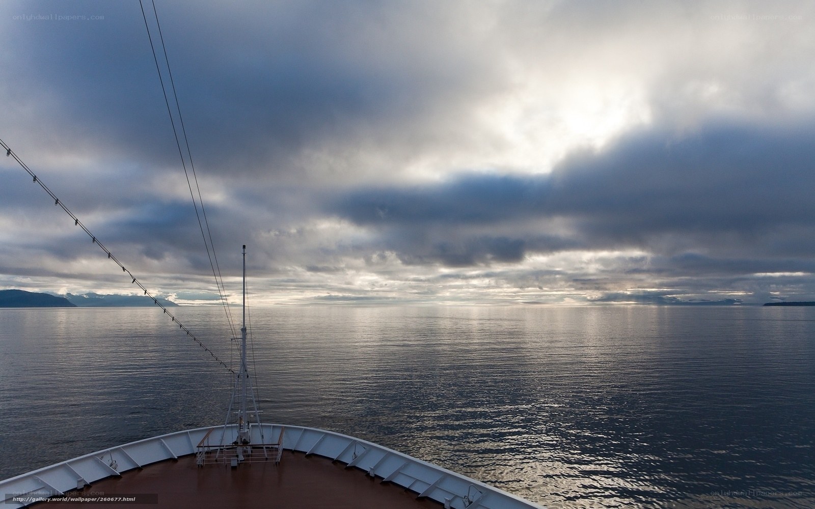 Ship at sea under cloudy sky