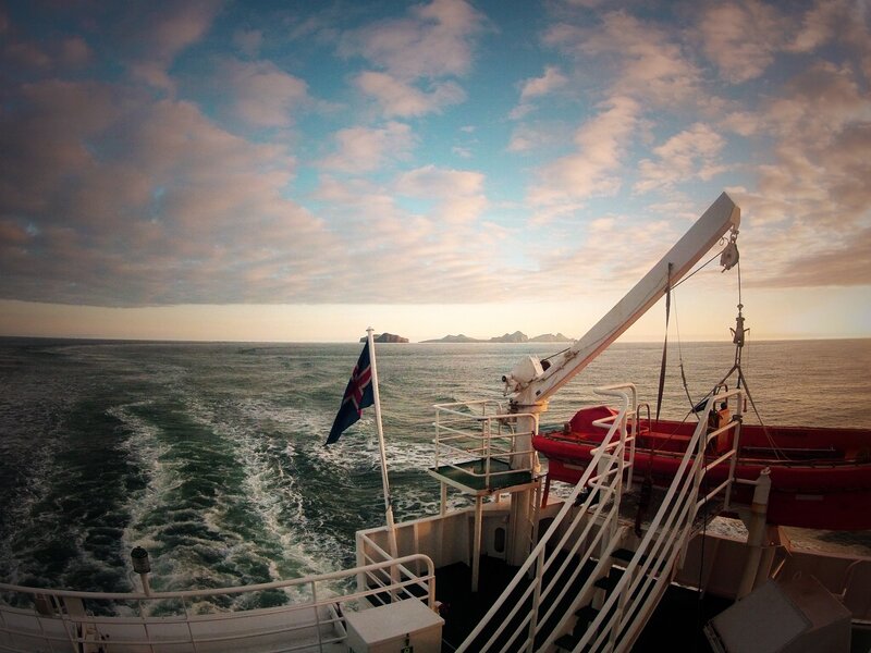 Ship at sea with island view