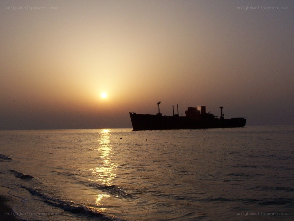 ship at sunset on calm sea