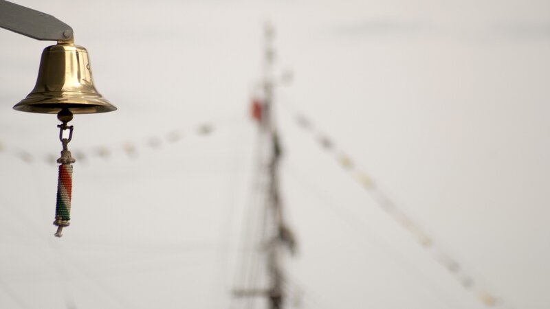 ship bell with mast in background