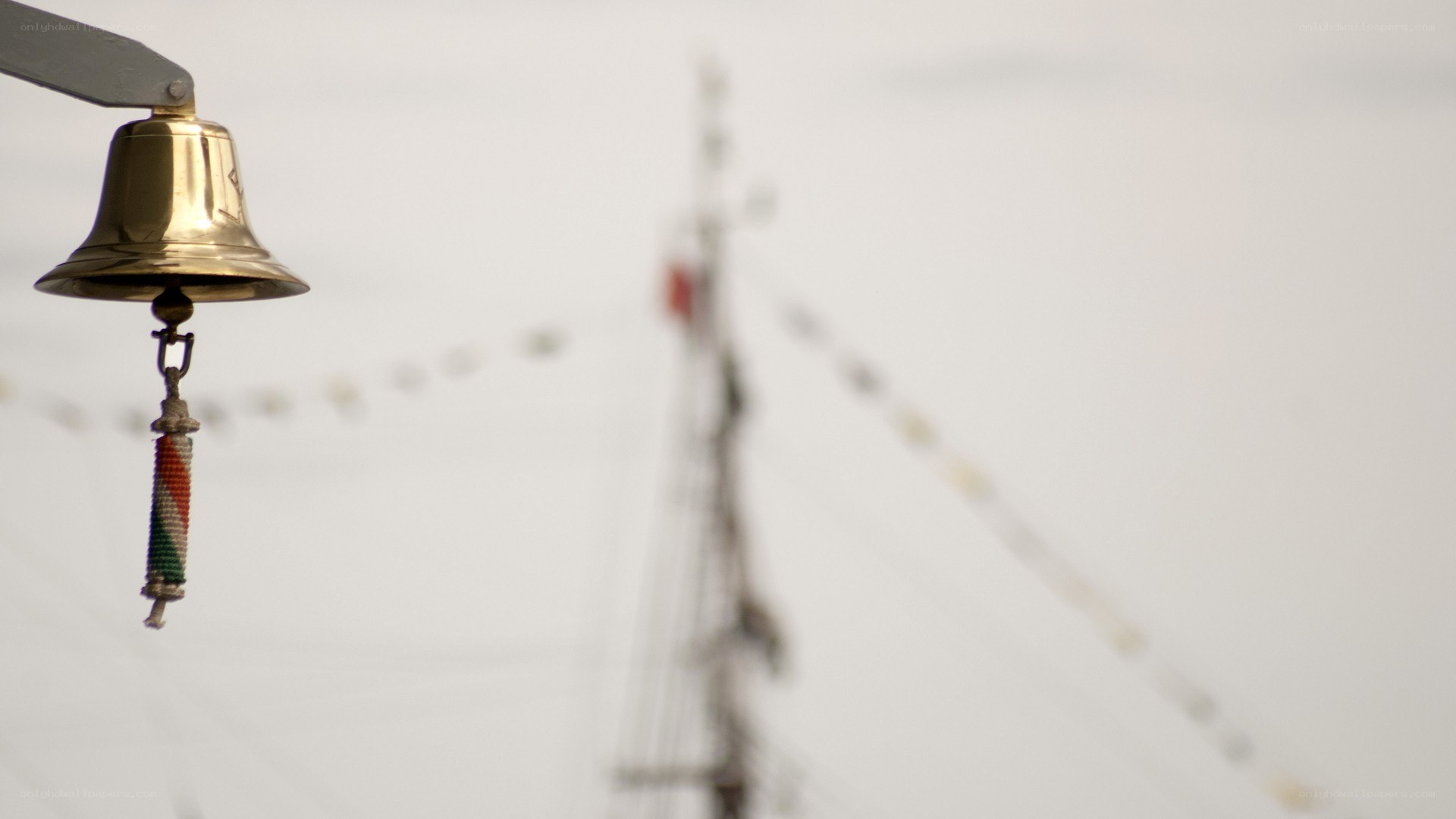 ship bell with mast in background