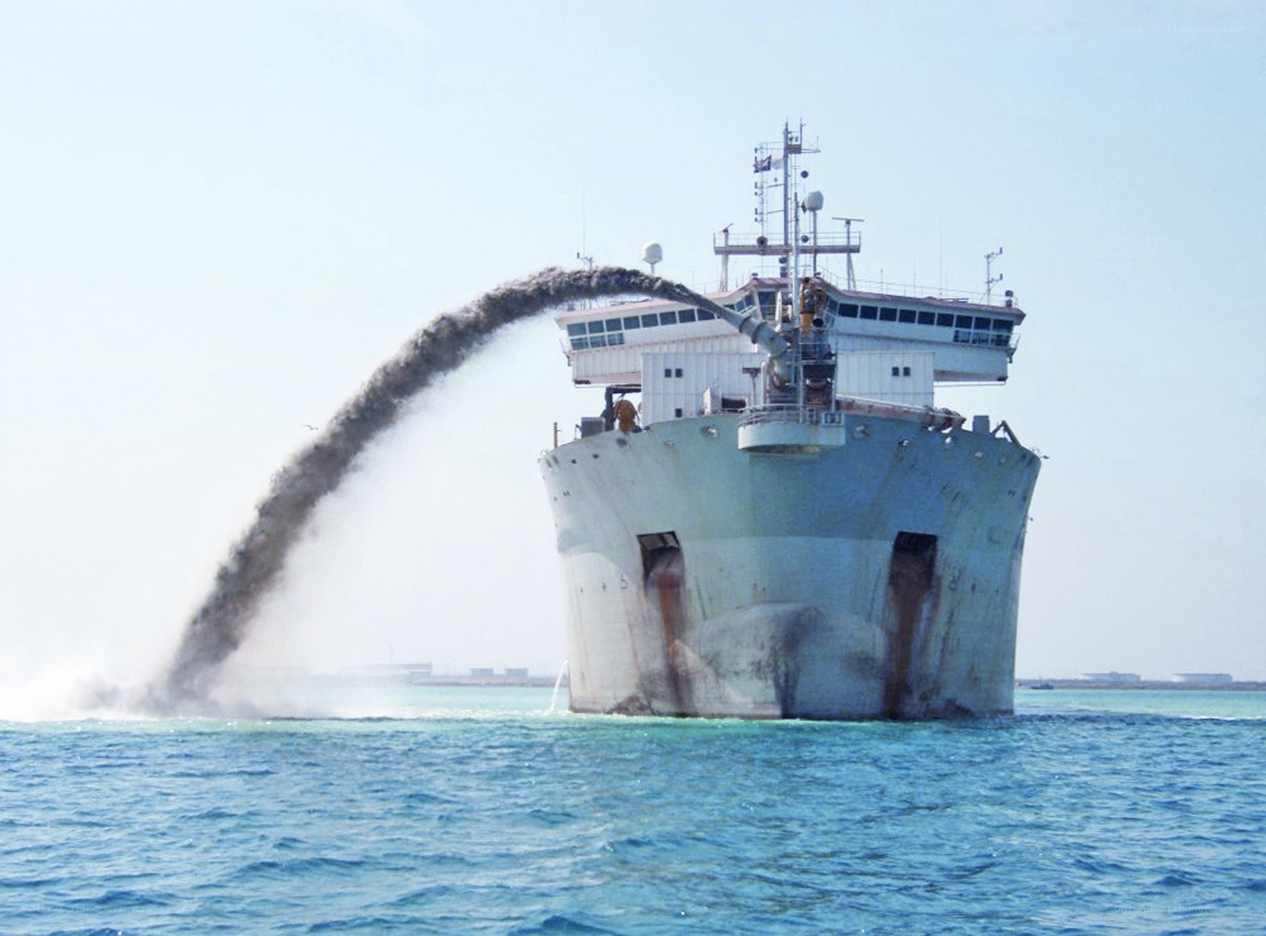 Ship discharging material at sea