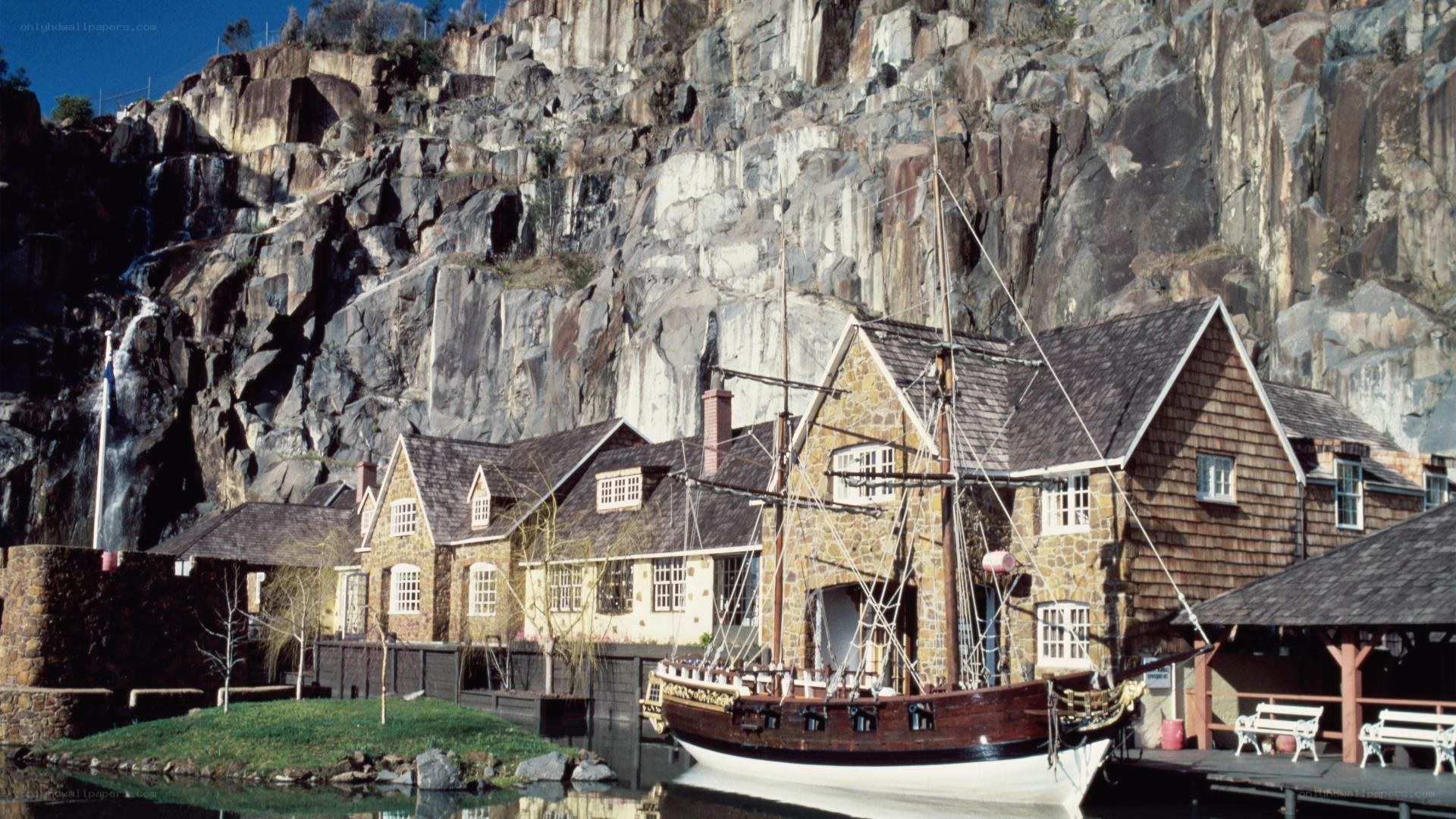 ship docked by stone buildings