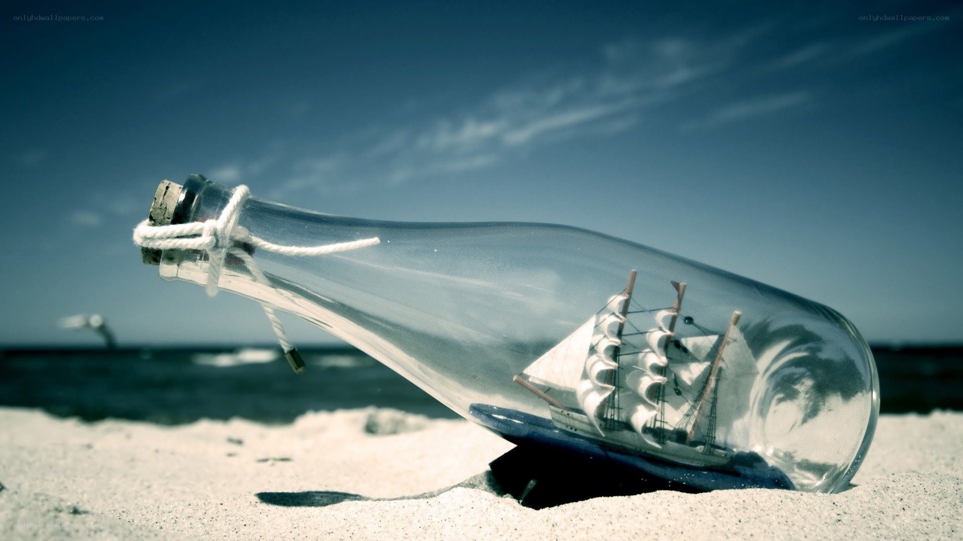 ship in a bottle on beach