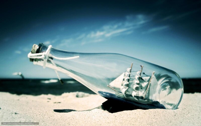 ship in a bottle on beach