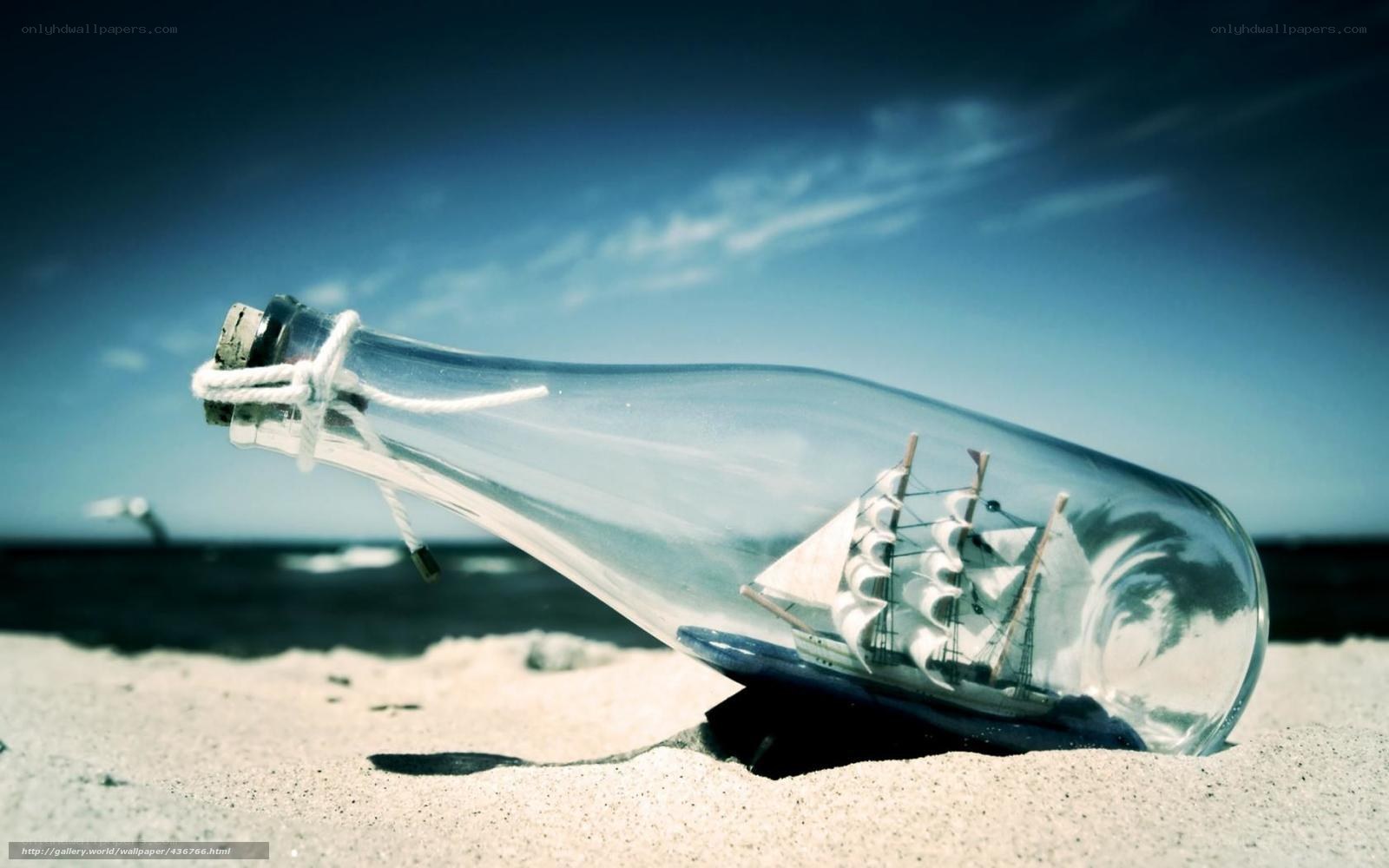 ship in a bottle on beach