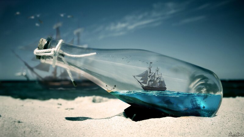 ship in a bottle on beach