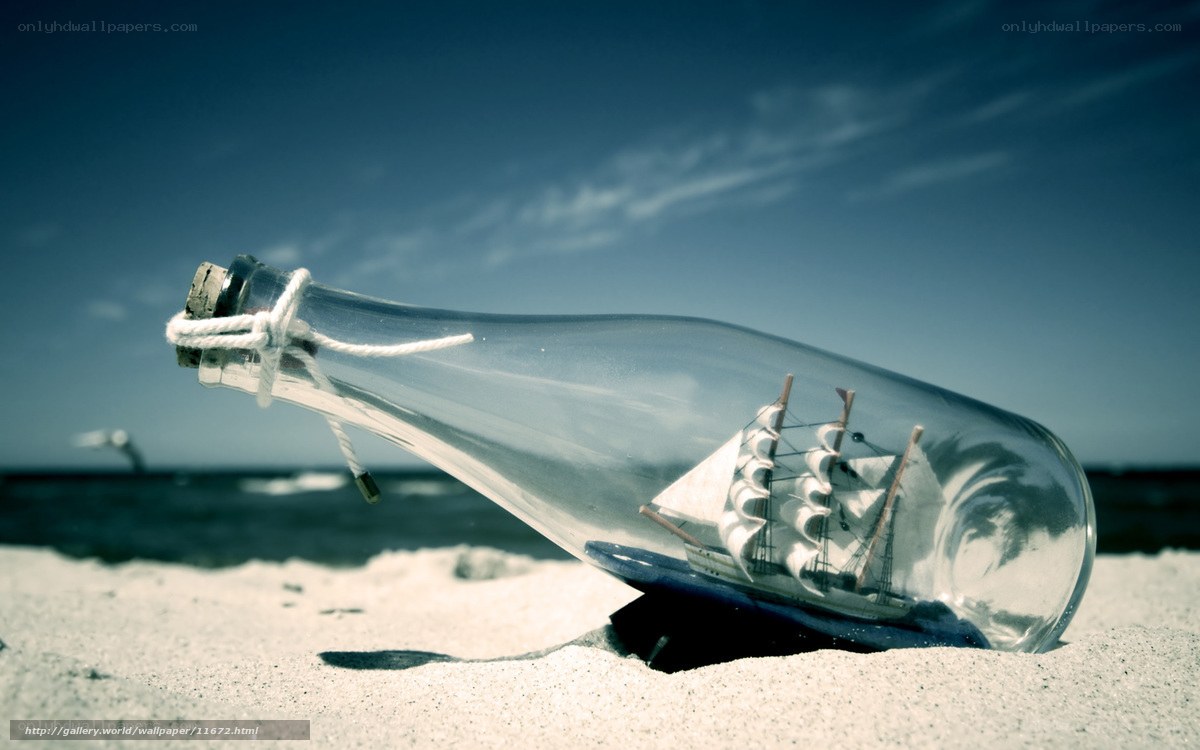 ship in a bottle on beach